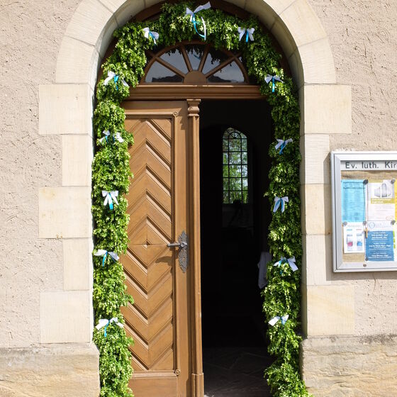 Kranz zur Konfirmation an der Tür der St. Johannis Kirche in Bodenburg